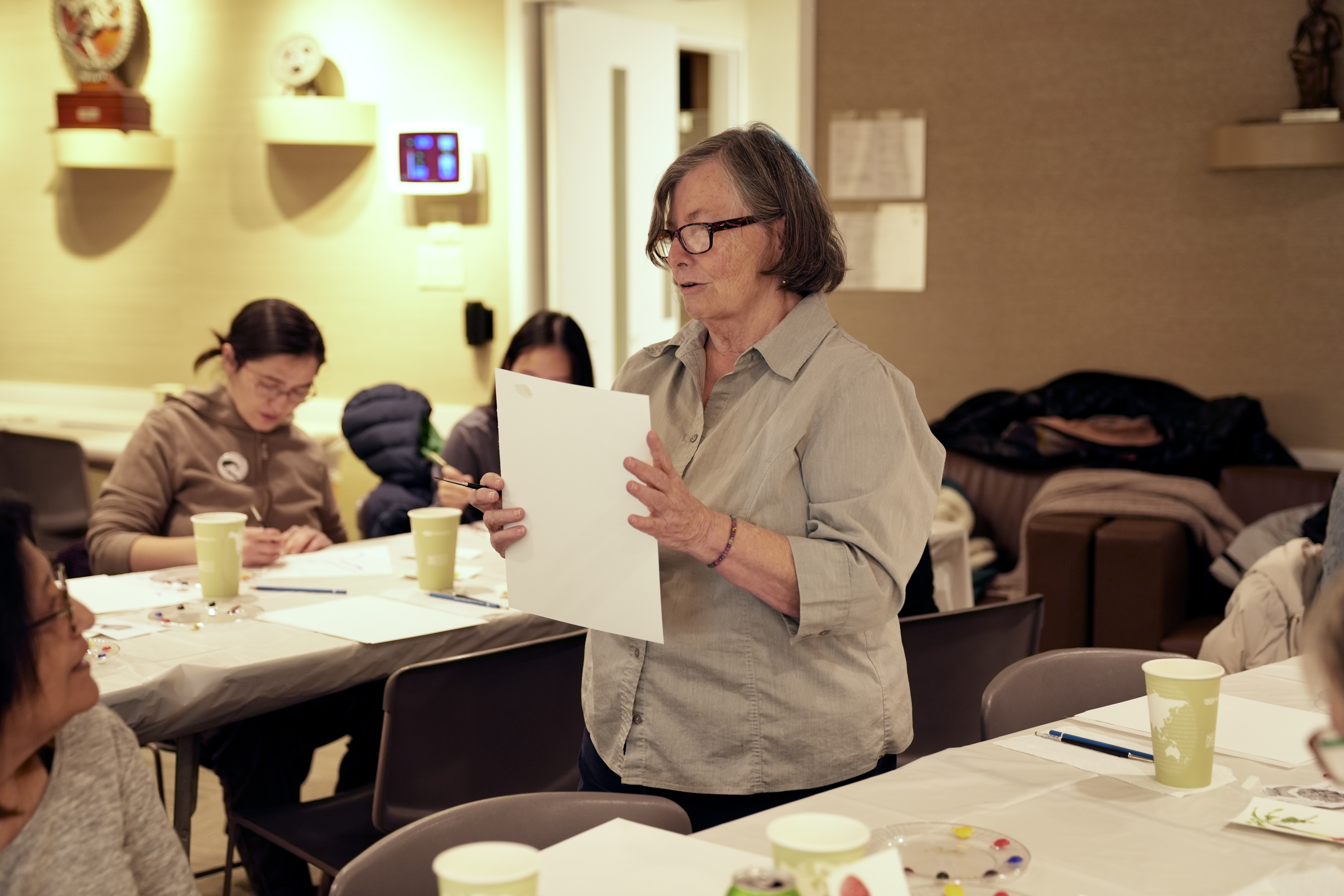 Donna Torres standing holding a piece of paper