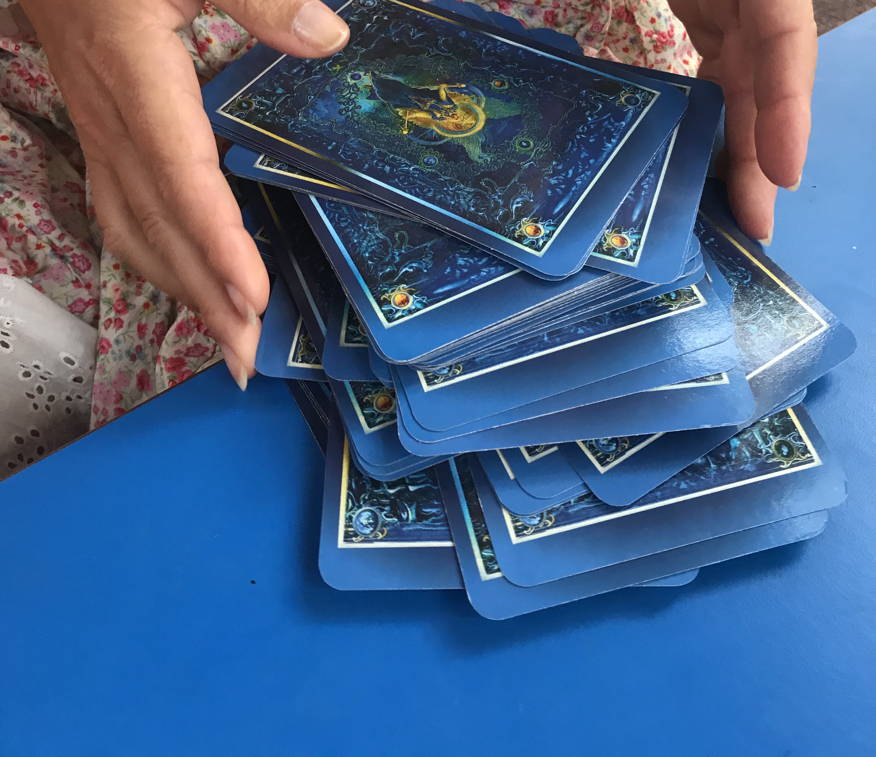 Hands loosely holding a deck of Tarot Cards