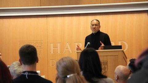 A speaker presenting to an interested audience at Harvard Divinity School