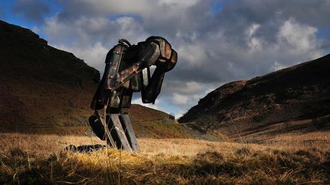 Large humanoid robot with head in hands