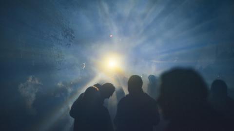 Large gathering againt bright light