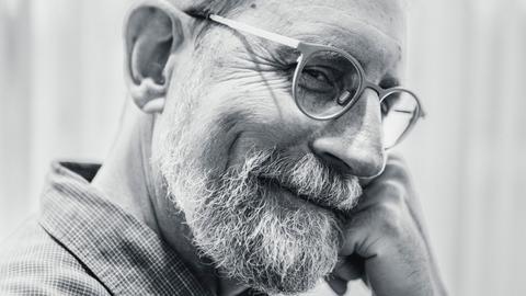 Erik Davis, check on fist, smiling sideways into the camera