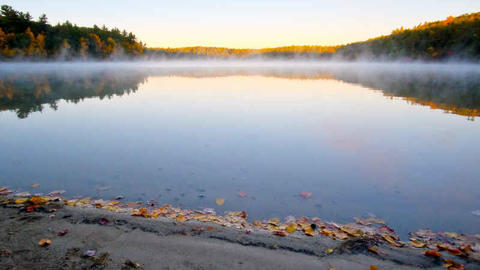 Walden pond with mist coming up from the water at sunset