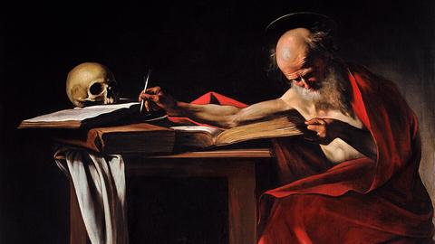 Image of a man wearing a red robe, writing something