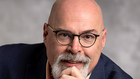 John Lysaker, chin in hand, looking into the camera