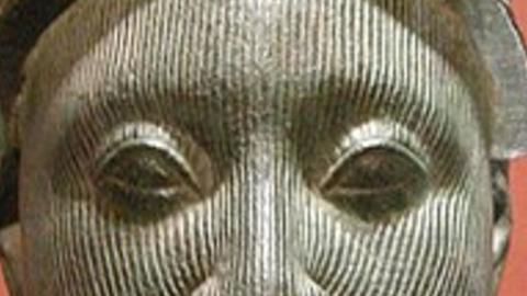 wooden sculpture with eyes and nose visible
