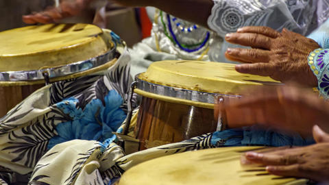 Image of individuals playing percussion instruments
