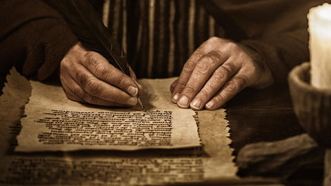 Image of an individual writing on a piece of paper