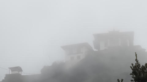 Image of a monastery shrouded in clouds