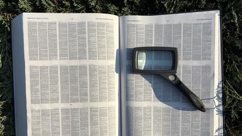 A dictionary with magnifying glass