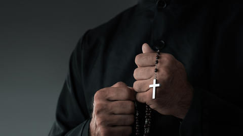 man with a cross in hand