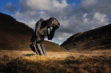 Large humanoid robot with head in hands