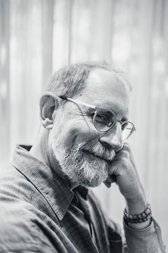 Erik Davis, check on fist, smiling sideways into the camera