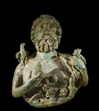 Stone statue from torso up of the god Mithras