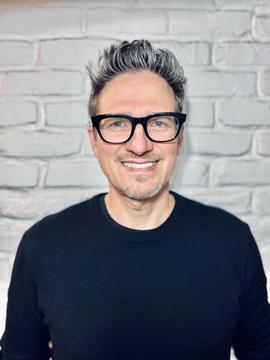 Stuart Sarbacker smiling into the camera