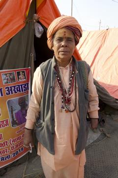 Woman in head scarf with tent in background