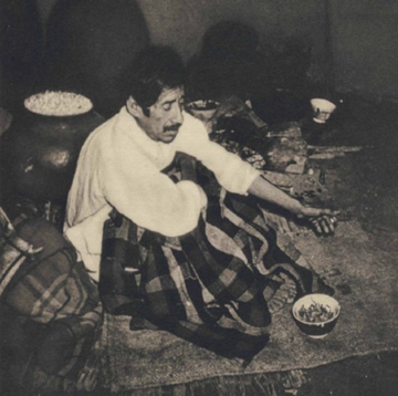 Photo of Macias, seated with blanket over knees with bowl of mushrooms