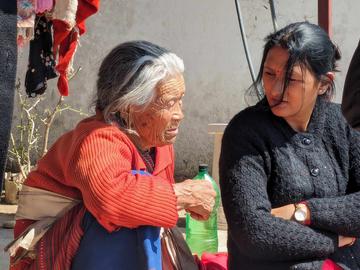 Discussing a depiction of hell with a delog. Kathmandu, Nepal