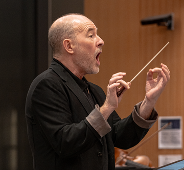 Ensemble Conductor facing musicians