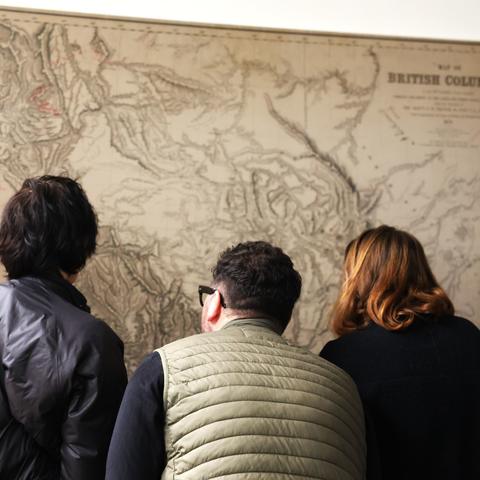 BC field trip participants looking at a map