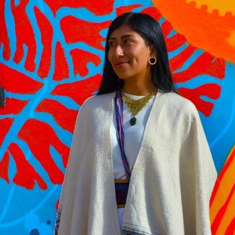 Image of Nicolle standing in front of colorful wall