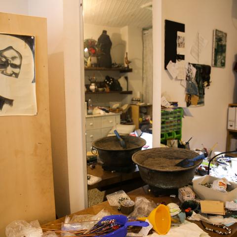 The artist's studio, table cluttered with materials
