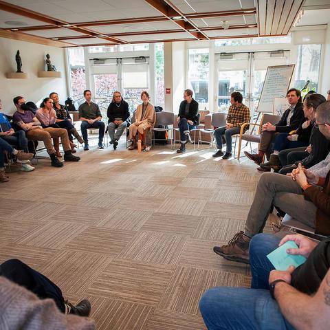 photo from workshop, attendees sitting in a large circle