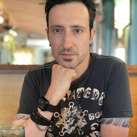 Jason Storm looking reflectively into the camera