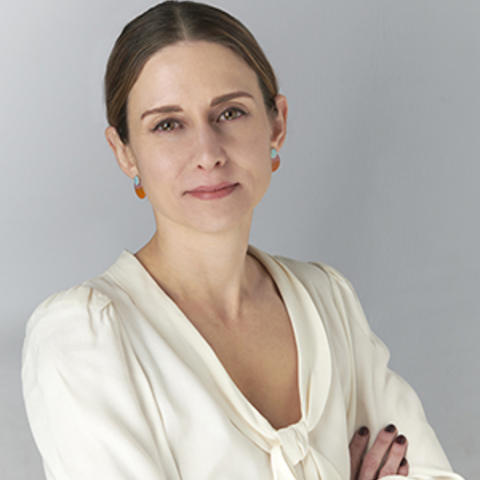 Lydia Willsky-Ciollo, arms crossed looking into the camera