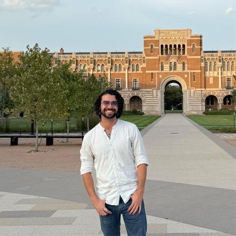 Max Wetter, smiling, standing in front of an academic building