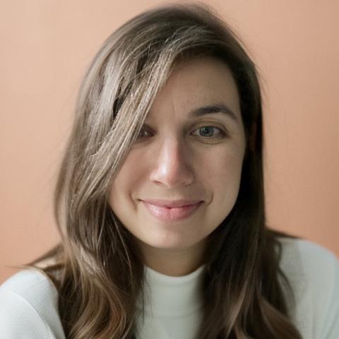 Rebecca Migdal looking into the camera.