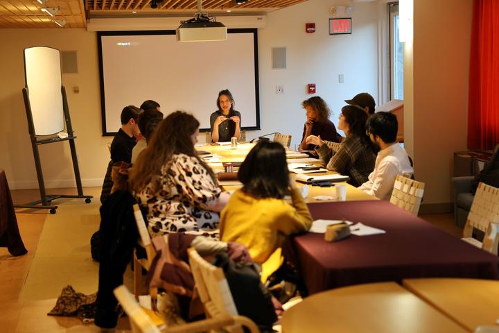Students sitting at a conference table listening to the instructor
