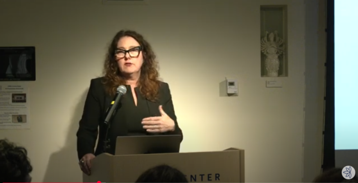 Jennifer Scheper Hughes at the podium