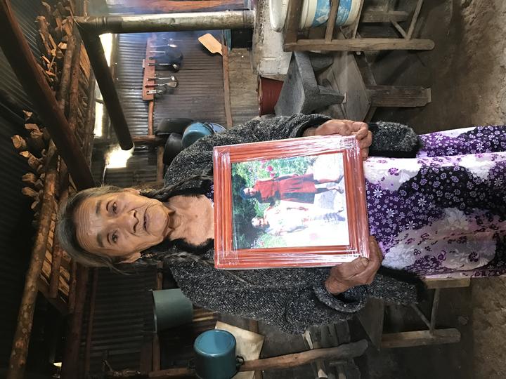 the niece of Maria Sabina, Rosalia, holding a photo of her aunt. 