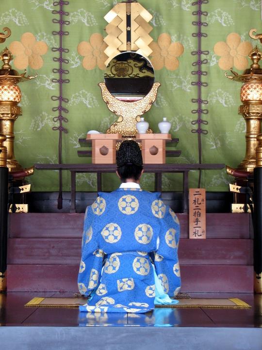Religious altar with person kneeling at it 