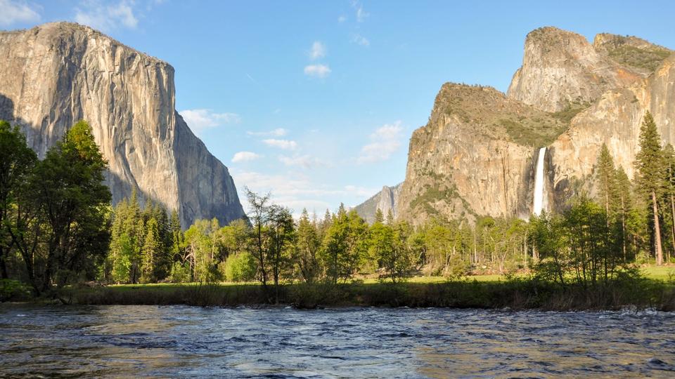 A body of water with rock faces in the distance