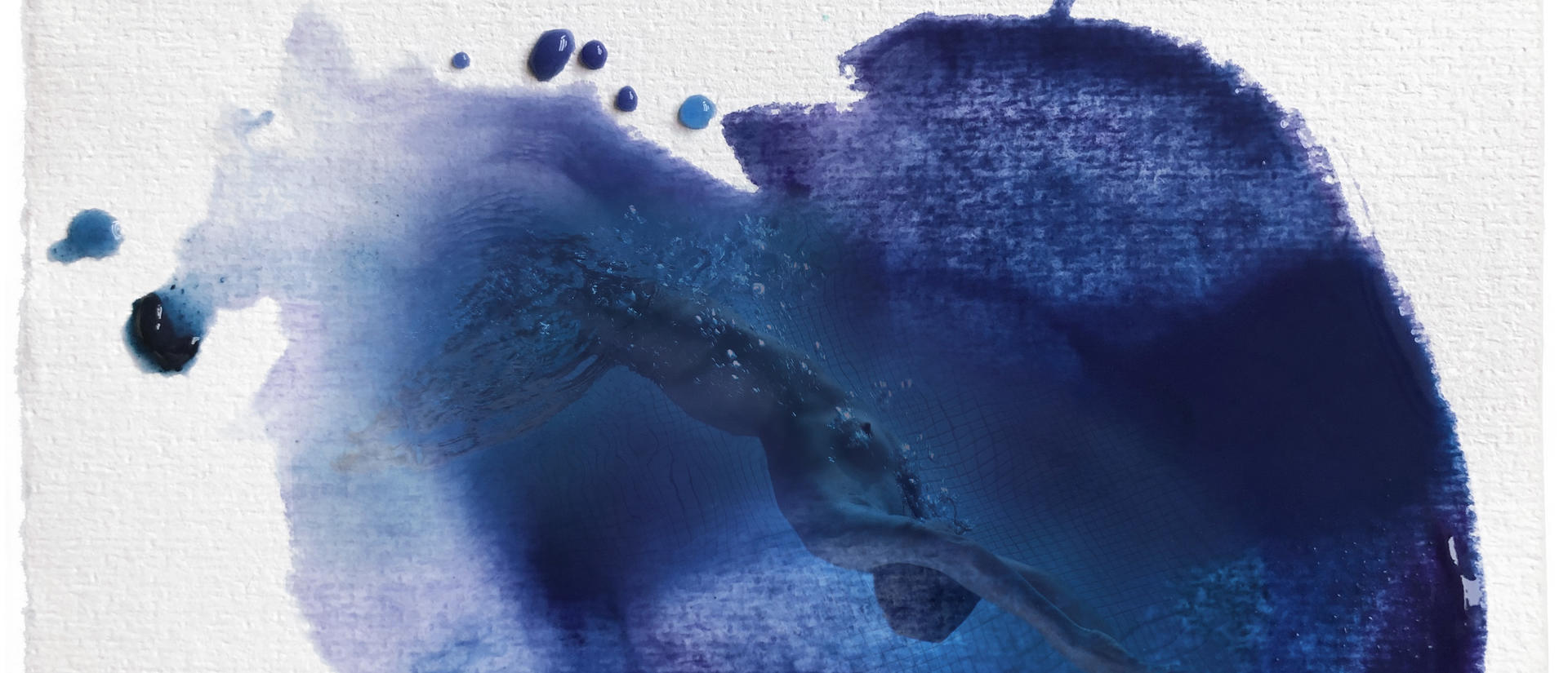 A blue ink splotch with photographic details