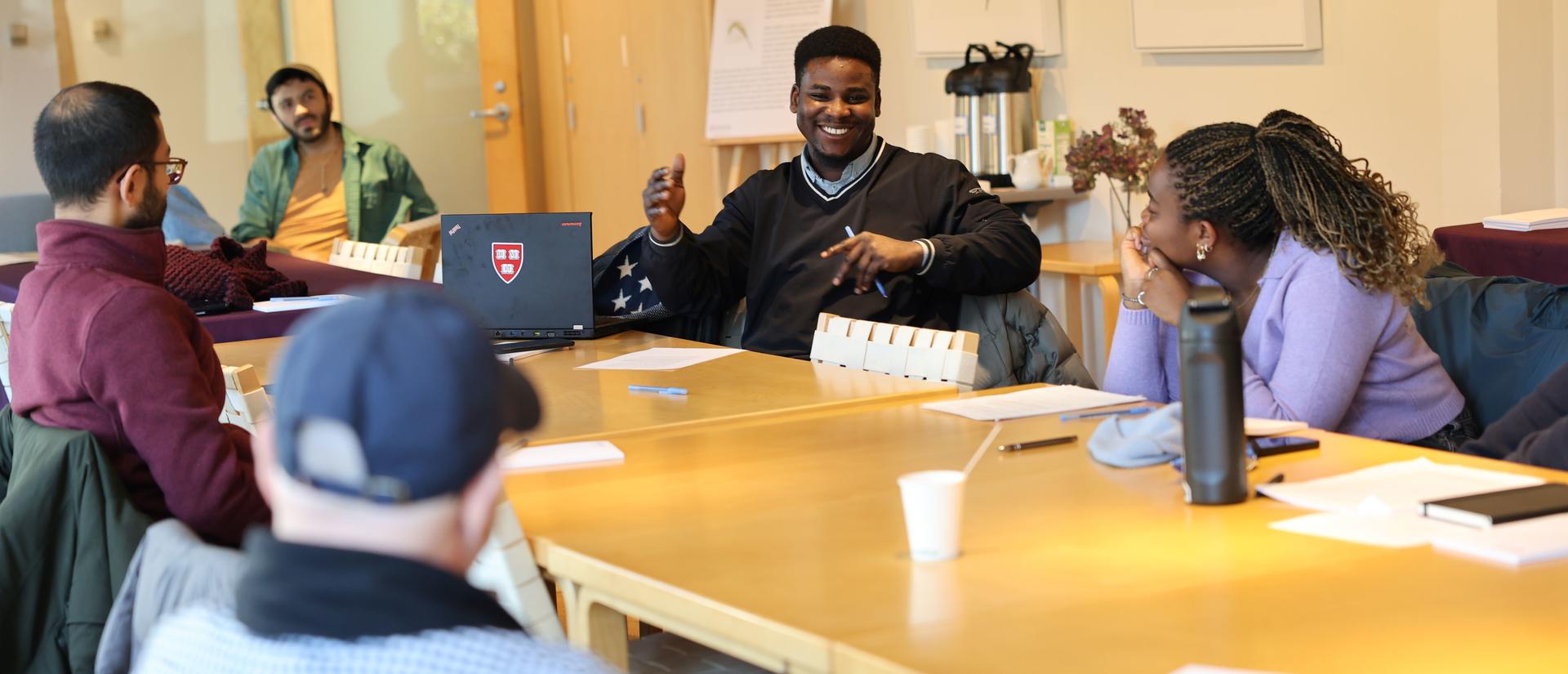 Students sitting at a conference table talking