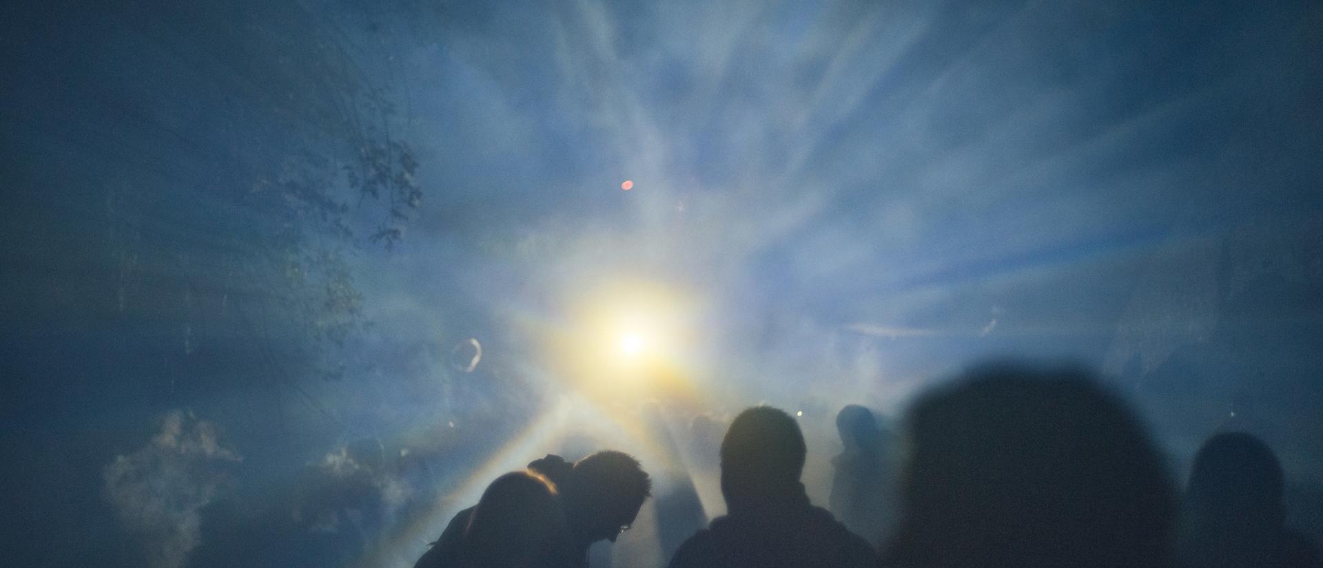 Large gathering againt bright light