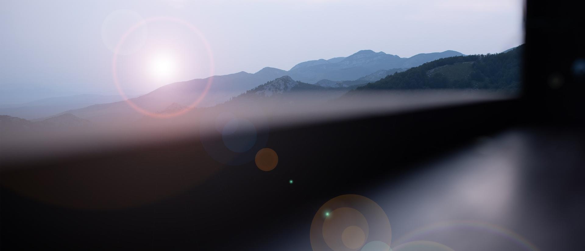 Sunlight streaming through with mountains in the background
