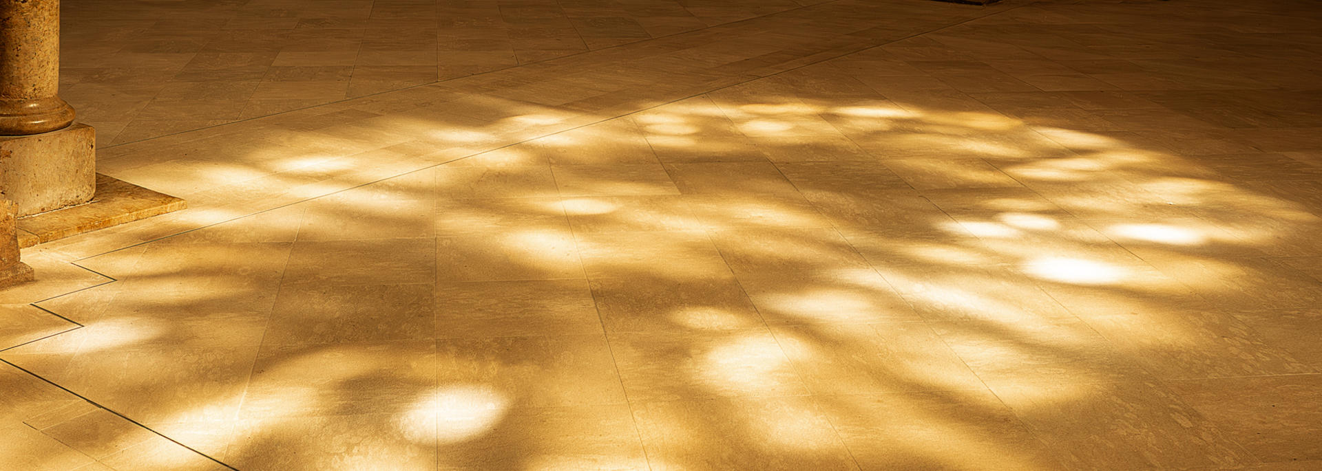 Sunlight streaming through windows on a stone floor