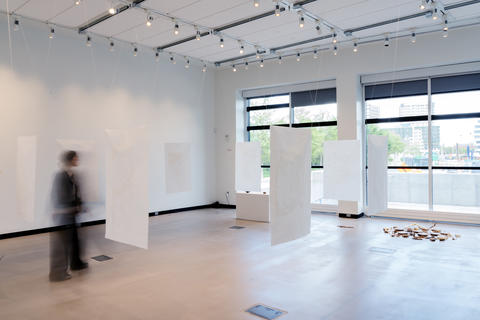 Blurred image of woman walking through art installation