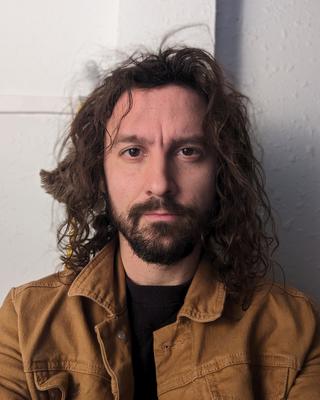 Simon Cox looking into the camera