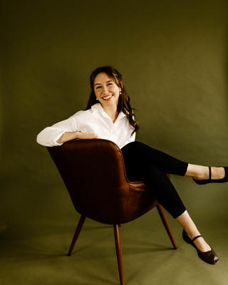 Katie Clem seated smiling into the camera