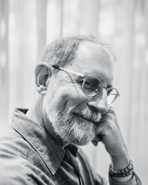 Erik Davis, check on fist, smiling sideways into the camera