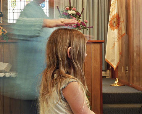 Young girl in profile someone holding something over her head